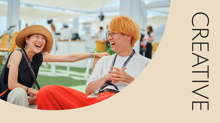 Two attendees laughing during the Creative Academy at Cannes Lions.