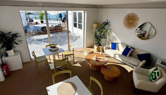 A room with tables, chairs and a sofa at Cannes Lions.